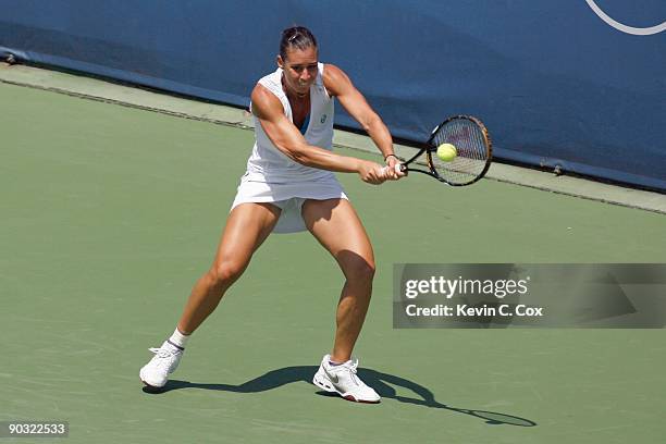 Flavia Pennetta of Italy returns a shot to Venus Williams during Day 4 of the Western & Southern Financial Group Women's Open on August 13, 2009 at...