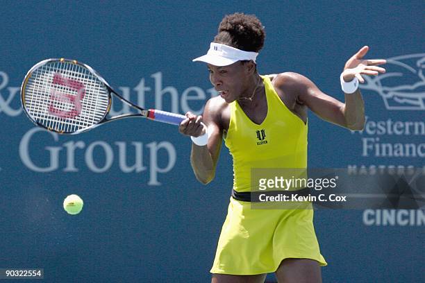 Venus Williams returns the ball to Flavia Pennetta of Italy during Day 4 of the Western & Southern Financial Group Women's Open on August 13, 2009 at...