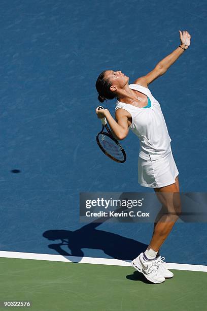 Flavia Pennetta of Italy serves to Venus Williams during Day 4 of the Western & Southern Financial Group Women's Open on August 13, 2009 at the...