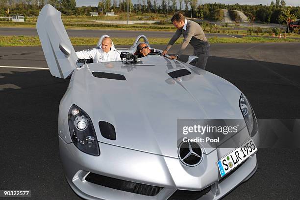 National player Robert Enke, racing driver Klaus Ludwig and National team manager Oliver Bierhoff pose in front of the Mercedes-Benz SLR McLaren...