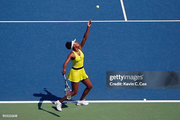 Venus Williams serves to Flavia Pennetta of Italy during Day 4 of the Western & Southern Financial Group Women's Open on August 13, 2009 at the...