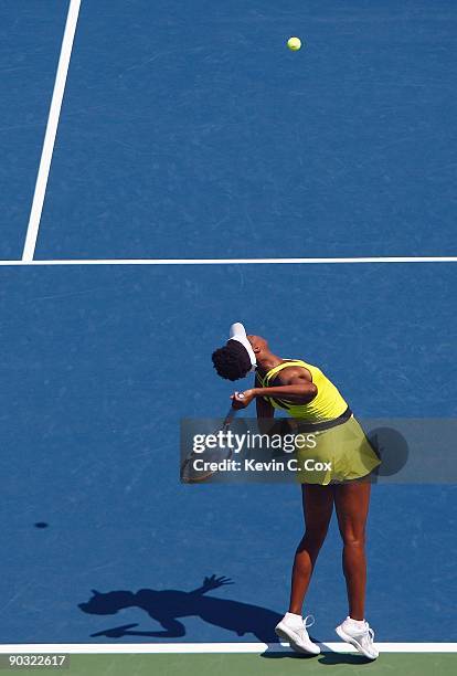 Venus Williams serves to Flavia Pennetta of Italy during Day 4 of the Western & Southern Financial Group Women's Open on August 13, 2009 at the...