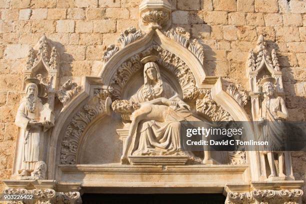 intricately carved pieta above doorway of the franciscan monastery, dubrovnik, croatia - pieta stock pictures, royalty-free photos & images