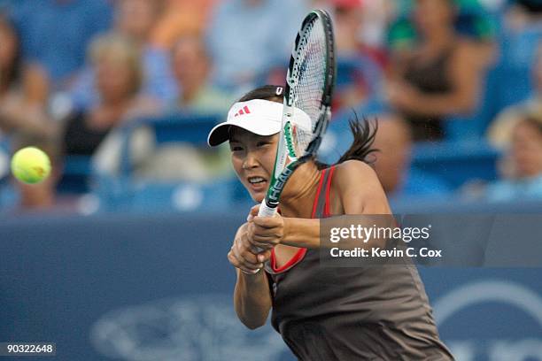 Shuai Peng of China returns a shot to Dinara Safina of Russia during Day 4 of the Western & Southern Financial Group Women's Open on August 13, 2009...