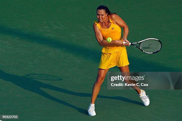 Jelena Jankovic of Serbia returns a shot to Victoria Azarenka of Belarus during Day 4 of the Western & Southern Financial Group Women's Open on...