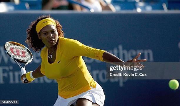 Serena Williams returns a shot during Day 4 of the Western & Southern Financial Group Women's Open on August 13, 2009 at the Lindner Family Tennis...