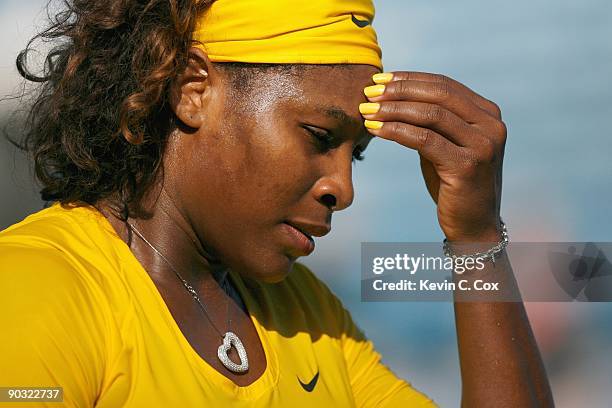 Serena Williams reacts after losing a game to Sybille Bammer of Austria during Day 4 of the Western & Southern Financial Group Women's Open on August...