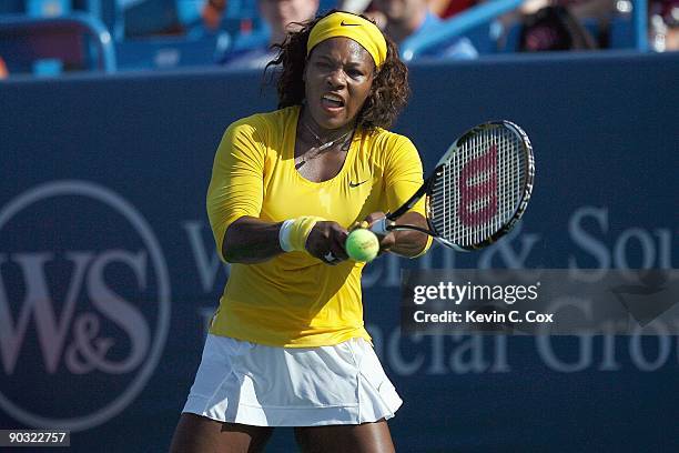 Serena Williams returns a shot during Day 4 of the Western & Southern Financial Group Women's Open on August 13, 2009 at the Lindner Family Tennis...