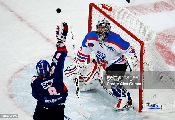 Goalkeeper Patrick Ehelechner of Nuernberg watches James Pollock of Mannheim try to catch the puck during the DEL match between Adler Mannheim and...