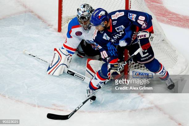Francois Methot of Mannheim tries to score against goalkeeper Patrick Ehelechner of Nuernberg during the DEL match between Adler Mannheim and Ice...