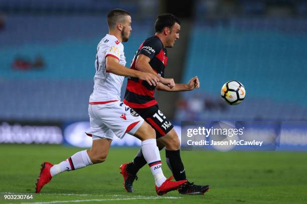 Apolstolos Stamatelopoulos of Adelaide and Mark Bridge of the Wanderers compete for the ball during the round 15 A-League match between the Western...