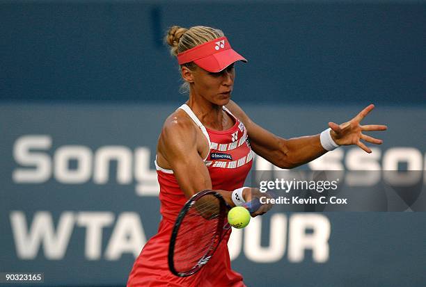 Elena Dementieva of Russia returns a shot to Jelena Jankovic of Serbia during the semifinals of the Western & Southern Financial Group Women's Open...