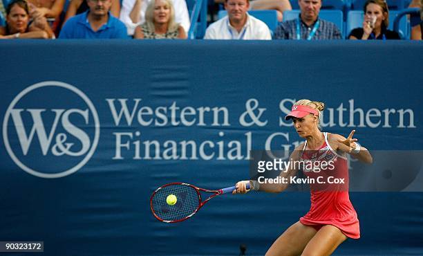 Elena Dementieva of Russia returns a shot to Jelena Jankovic of Serbia during the semifinals of the Western & Southern Financial Group Women's Open...