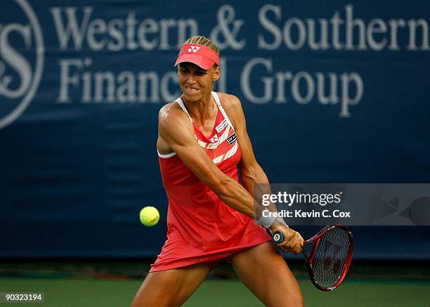 Elena Dementieva of Russia returns a shot to Jelena Jankovic of Serbia during the semifinals of the Western & Southern Financial Group Women's Open...