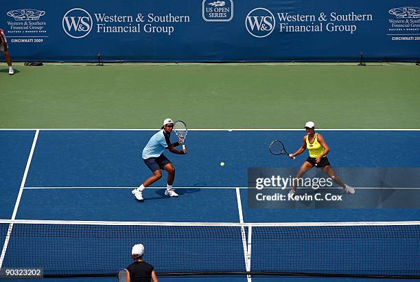 Akgul Amanmuradova of Uzbekistan and Monica Niculescu of Romania volley a shot back to Cara Black of Zimbabwe and Liezel Huber during the semifinals...