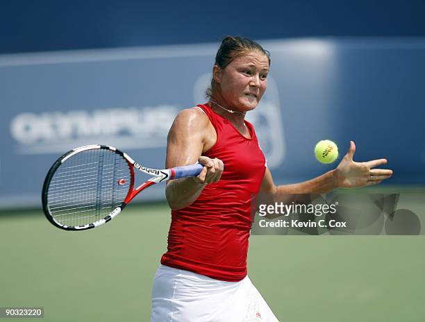 Dinara Safina of Russia returns a shot to Flavia Pennetta of Italy in the semifinals of the Western & Southern Financial Group Women's Open on August...