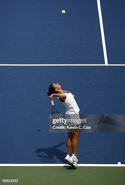 Flavia Pennetta of Italy serves to Dinara Safina of Russia in the semifinals of the Western & Southern Financial Group Women's Open on August 15,...