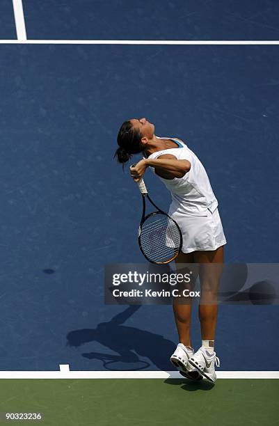 Flavia Pennetta of Italy serves to Dinara Safina of Russia in the semifinals of the Western & Southern Financial Group Women's Open on August 15,...