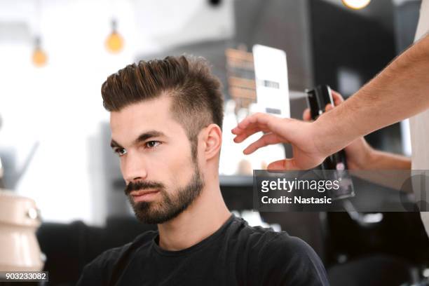 hairdresser spraying hair - man hairstyle stock pictures, royalty-free photos & images