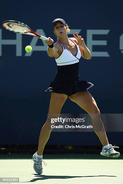 Alize Cornet of France returns a shot against Jie Zheng of China during day four of the 2009 U.S. Open at the USTA Billie Jean King National Tennis...