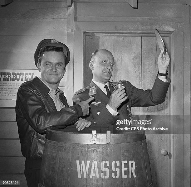 Bob Crane as Col. Robert E. Hogan, left, Werner Klemperer as Col. Wilhelm Klink in ?Go Light On the Heavy Water?, an episode from the CBS television...