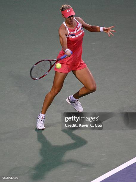 Elena Dementieva of Russia returns a shot to Jelena Jankovic of Serbia during the semifinals of the Western & Southern Financial Group Women's Open...