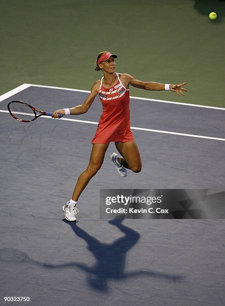 Elena Dementieva of Russia returns a shot to Jelena Jankovic of Serbia during the semifinals of the Western & Southern Financial Group Women's Open...