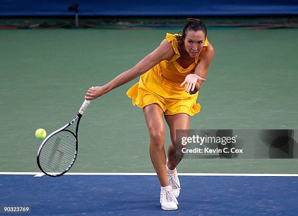 Jelena Jankovic of Serbia returns a shot to Elena Dementieva of Russia during the semifinals of the Western & Southern Financial Group Women's Open...