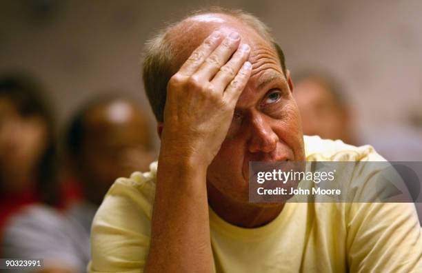 Homeowner listens during a foreclosure prevention workshop held by the Adams County Housing Authority on September 3, 2009 in Commerce City,...