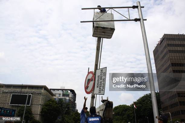 Jakarta Transportation Department officers dismantle traffic signs that prohibit two-wheeled vehicles passing on Jalan Mh. Thamrin, Central Jakarta,...