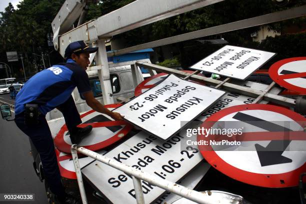 Jakarta Transportation Department officers dismantle traffic signs that prohibit two-wheeled vehicles passing on Jalan Mh. Thamrin, Central Jakarta,...