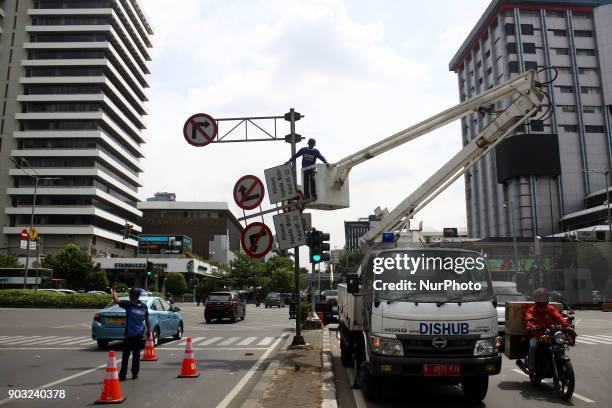 Jakarta Transportation Department officers dismantle traffic signs that prohibit two-wheeled vehicles passing on Jalan Mh. Thamrin, Central Jakarta,...