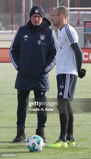 Team coach Jupp Heynckes of FC Bayern Muenchen talks to Arjen Robben during a training session at the club's Saebener Strasse training ground on...