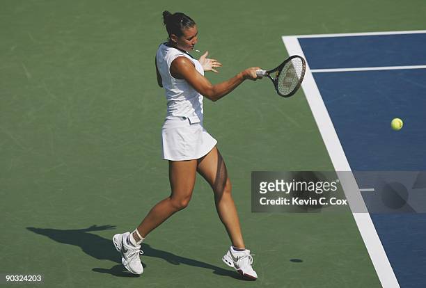 Flavia Pennetta of Italy returns a shot during Day 5 of the Western & Southern Financial Group Women's Open on August 14, 2009 at the Lindner Family...