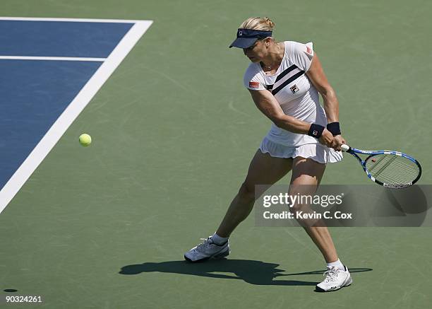 Kim Clijsters of Belgium returns a shot during Day 5 of the Western & Southern Financial Group Women's Open on August 14, 2009 at the Lindner Family...