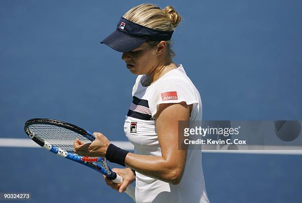 Kim Clijsters of Belgium looks at her racket during Day 5 of the Western & Southern Financial Group Women's Open on August 14, 2009 at the Lindner...