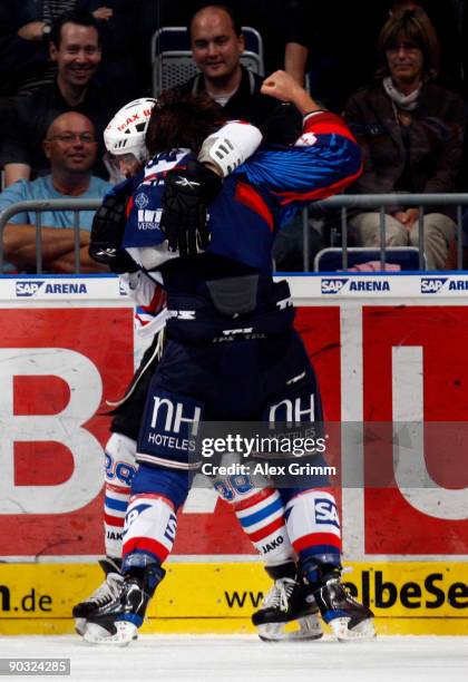 Felix Petermann of Mannheim fights with Brad Leeb of Nuernberg during the DEL match between Adler Mannheim and Ice Tigers Nuernberg at the SAP Arena...