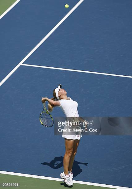 Caroline Wozniacki of Denmark serves during Day 5 of the Western & Southern Financial Group Women's Open on August 14, 2009 at the Lindner Family...