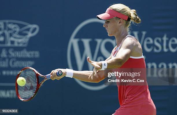 Elena Dementieva of Russia returns a shot during Day 5 of the Western & Southern Financial Group Women's Open on August 14, 2009 at the Lindner...