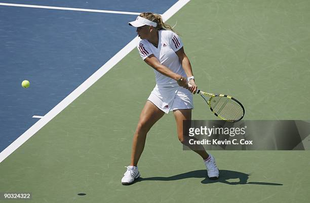 Caroline Wozniacki of Denmark returns a shot during Day 5 of the Western & Southern Financial Group Women's Open on August 14, 2009 at the Lindner...