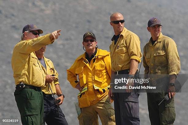 Firefighters discuss tactics on the western front of the 226-square-mile Station Fire in remote mountainous terrain east of Pacoima Canyon on...