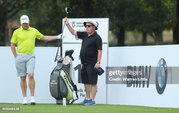 Jamie Donaldson of Wales is given a club by caddie Michael 'Mick' Donaghy as he plays a practice round ahead of the BMW South African Open...