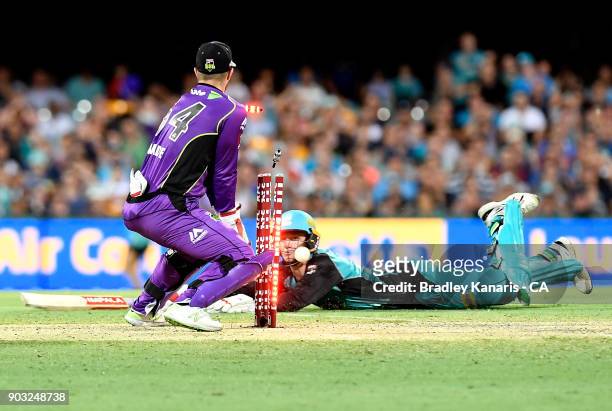 Brendan Doggett of the Heat makes his ground during the Big Bash League match between the Brisbane Heat and the Hobart Hurricanes at The Gabba on...