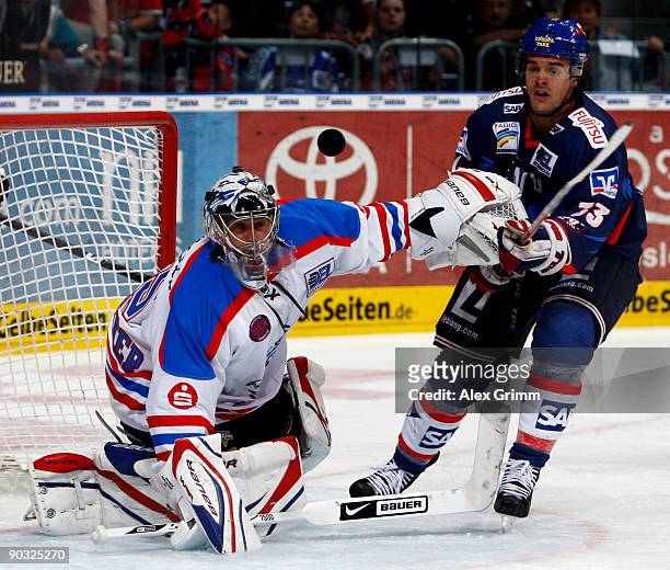 Goalkeeper Patrick Ehelechner of Nuernberg and Michael Hackert of Mannheim watch the puck during the DEL match between Adler Mannheim and Ice Tigers...