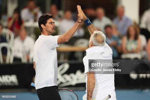 Mark Philippoussis of Australia and Mansour Bahrami of Iran competes in their match against Robby Ginepri of the USA and Henri Leconte of France on...