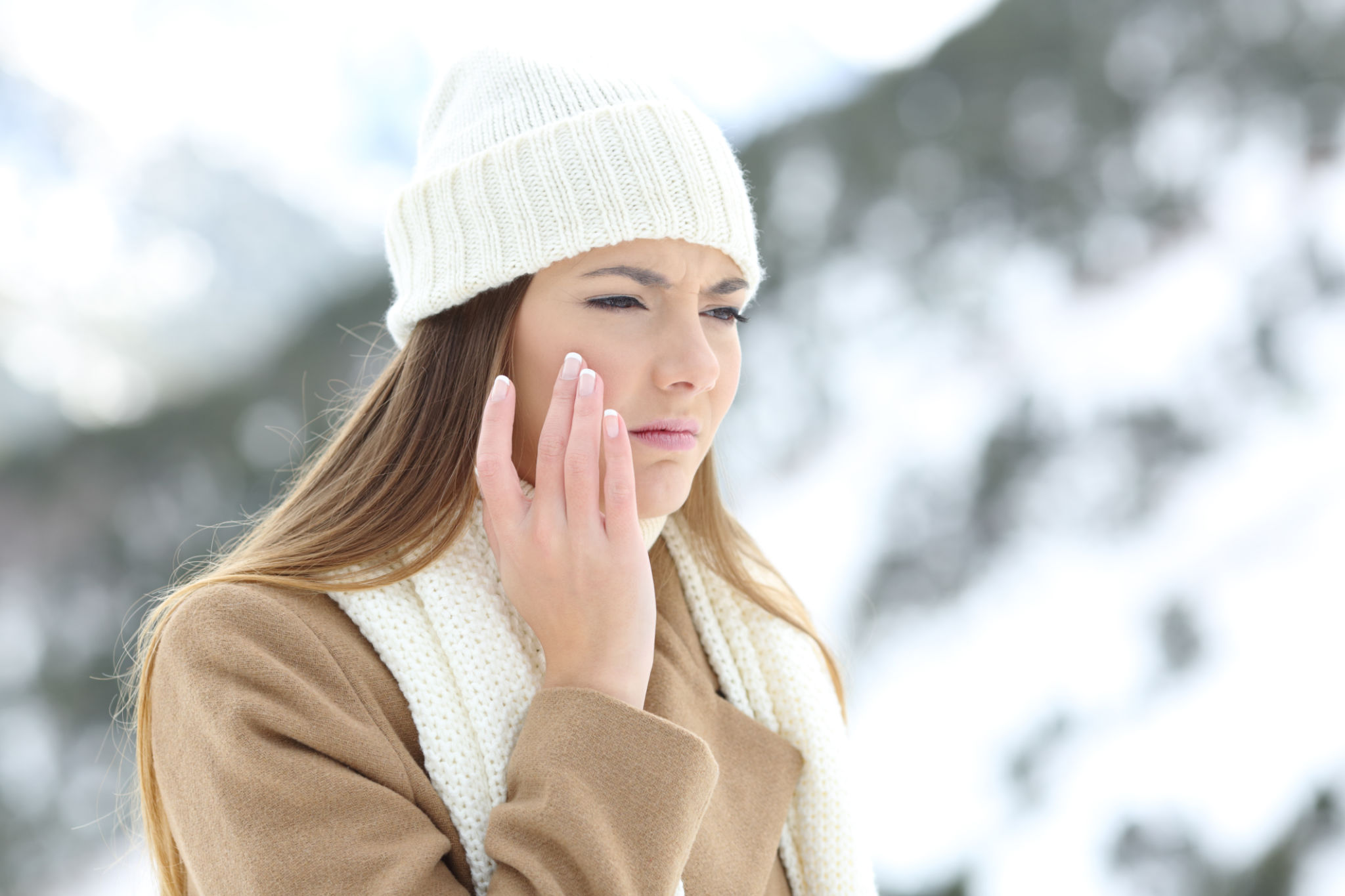 Angry woman using a sking protection cream in winter Angry woman using a sking protection cream in winter