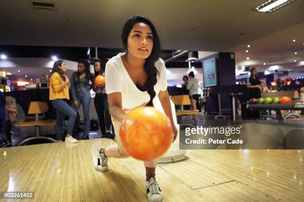 group of young women bowling - ten pin bowling stock pictures, royalty-free photos & images