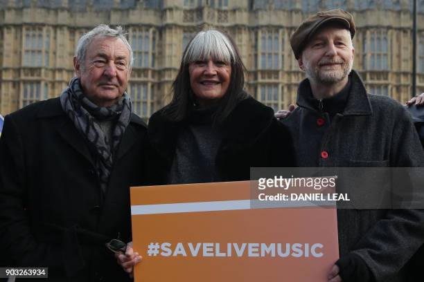 Pink Floyd drummer Nick Mason, British singer Sandy Shaw and British singer Billy Bragg pose during a protest outside the Houses of Parliament to...