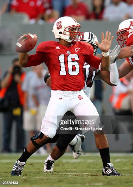 Quarterback Russell Wilson of the North Carolina State Wolfpack drops back to pass against the South Carolina Gamecocks during the game at...
