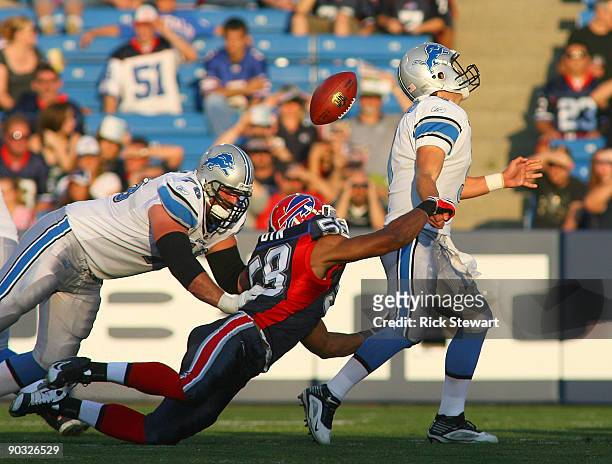 Aaron Mabin of the Buffalo Bills strips the ball from Matthew Stafford of the Detroit Lions at Ralph Wilson Stadium on September 3, 2009 in Orchard...
